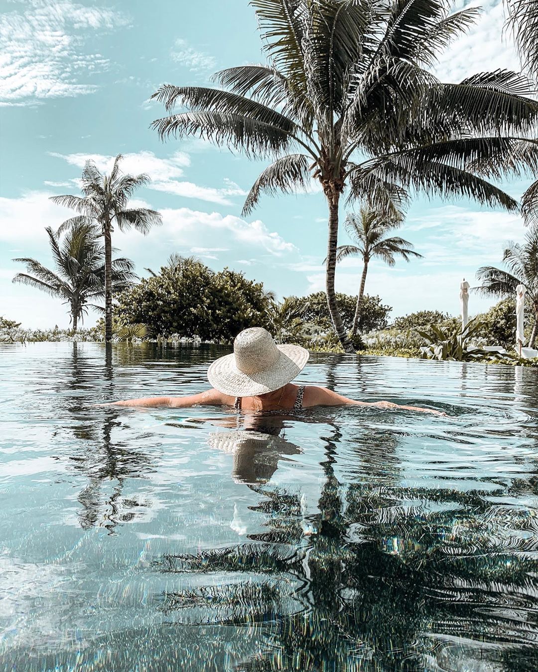 Woman in pool with head down.